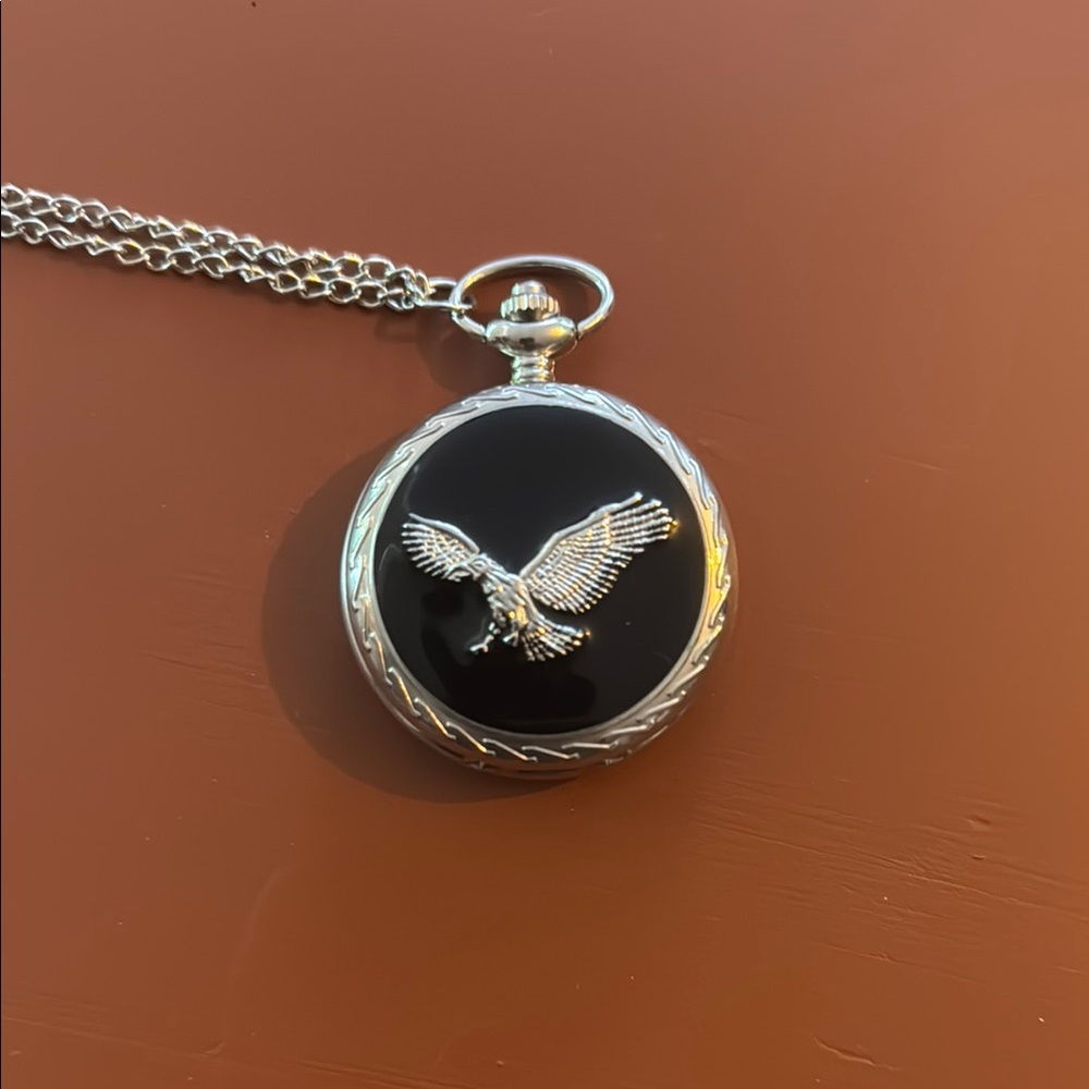Silver and Black Pocket Watch with Eagle Design